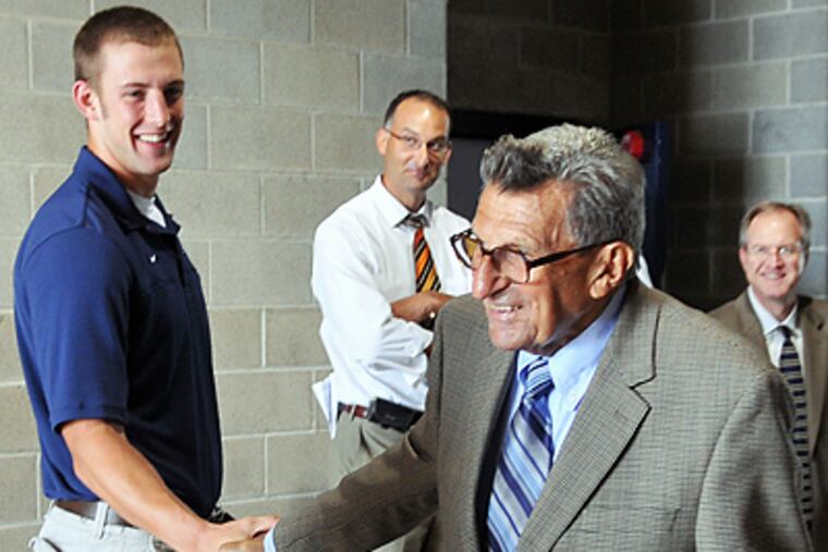 Penn State wide receiver Brett Brackett shakes hands with head coach Joe Paterno. (AP Photo/Pat Little)