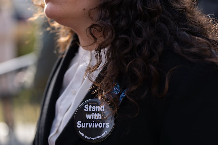 A woman wears a pin during a news conference on the Epstein Files Transparency Act Tuesday outside the U.S. Capitol in Washington.