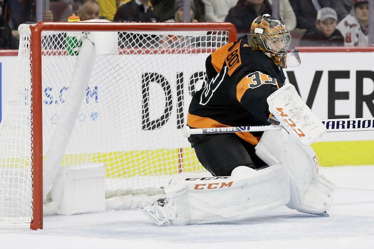 Flyers goalie Cam Talbot makes a stick save against the visiting Washington Capitals last season.