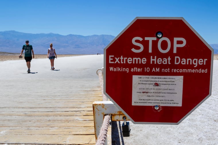 A sign warns people of extreme heat in multiple languages on July 11 in Death Valley National Park, Calif. July is the hottest month at the park with an average high of 116 degrees.