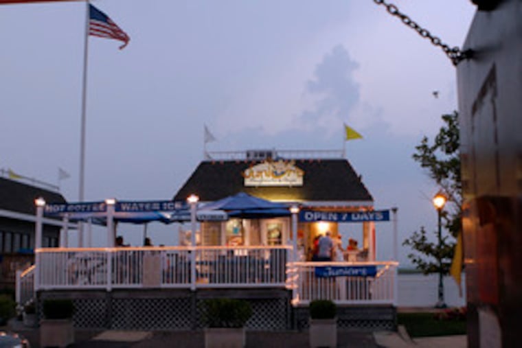 Patrons gather on the deck of Junior's. Regulars say that the neighborhood has matured along with them, and that last weekend's stabbing was an aberration.