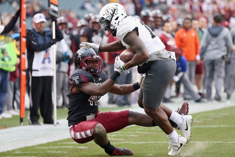 UCF wide receiver Marlon Williams (17) attempts to fend off Temple linebacker Todd Jones (40) during a game at Lincoln Financial Field on Saturday, Nov 18, 2017. Temple lost 45-19. TIM TAI / Staff Photographer