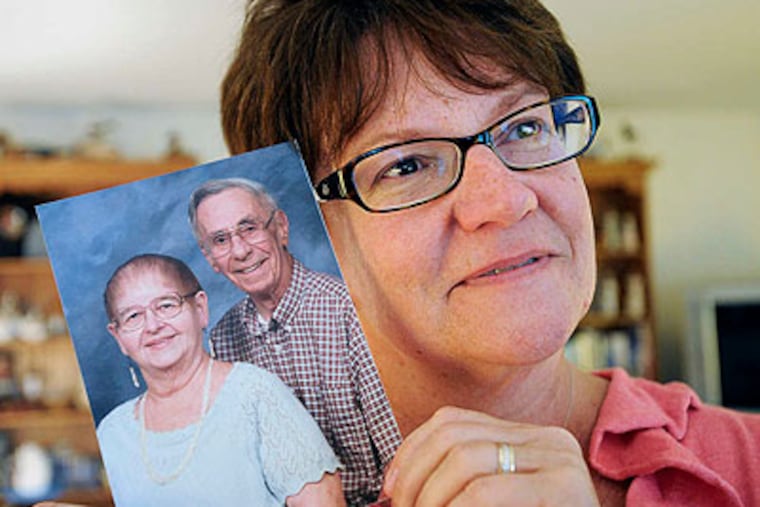 Beth Ricci with a picture of her parents, Don and Kay Clark. "They taught us about what love really is," she said. (Sharon Gekoski-Kimmel / Staff Photographer)