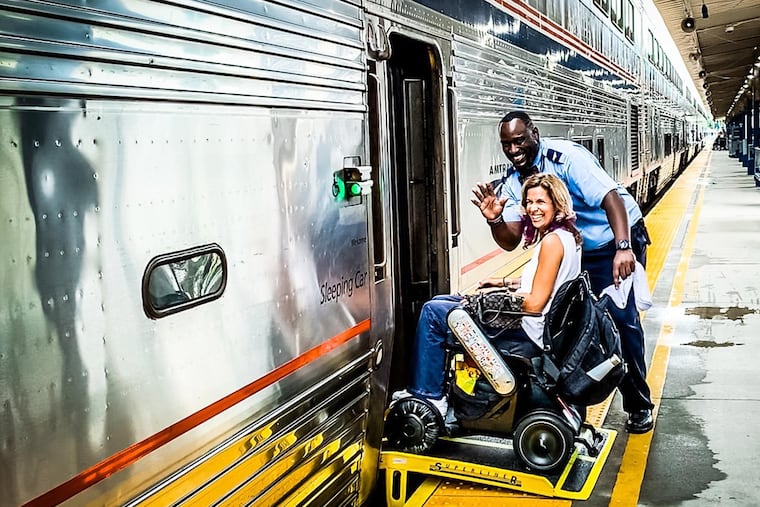 Amtrak employee Chris Desper, aka Big Chris, helps Sylvia Longmire board the Auto Train in Sanford, Fla.