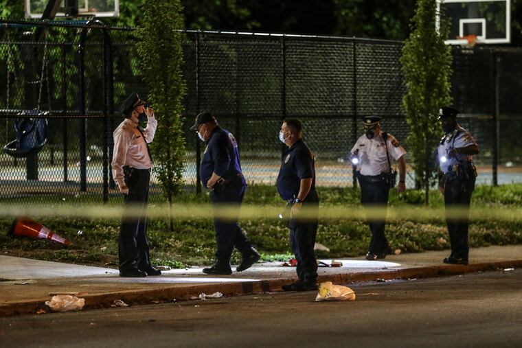 Police look for evidence where a teen was fatally shot and another wounded near the Deritis Playground in the 5600 block of Gray avenue in the 12th police district. Thursday May 13, 2021.