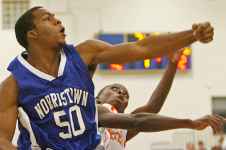 Norristown's Tom Smith swats away a shot by Chester's Kareem Robinson (rear). Each player scored 8 points as the Clippers continued their mastery over the Eagles in a 58-47 win.