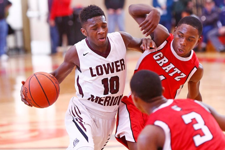 Lower Merion ballhandler Steve Payne collides with Simon Gratz defender Jamal Goode during the third quarter. Helping out on defense is the Bulldogs' Tyriek Meridith. Gratz went on to win, 63-61, in overtime Saturday (3/5/16) at Harriton in the first round of the PIAA Class AAAA boys' basketball playoffs. (LOU RABITO / Staff)