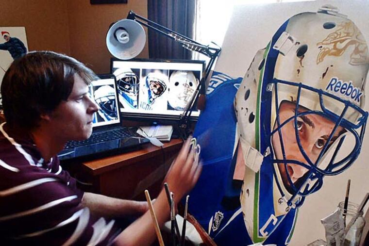 Michael Slotwinski adds finishing touches to a new piece (above) and stands with a gallery of his work.