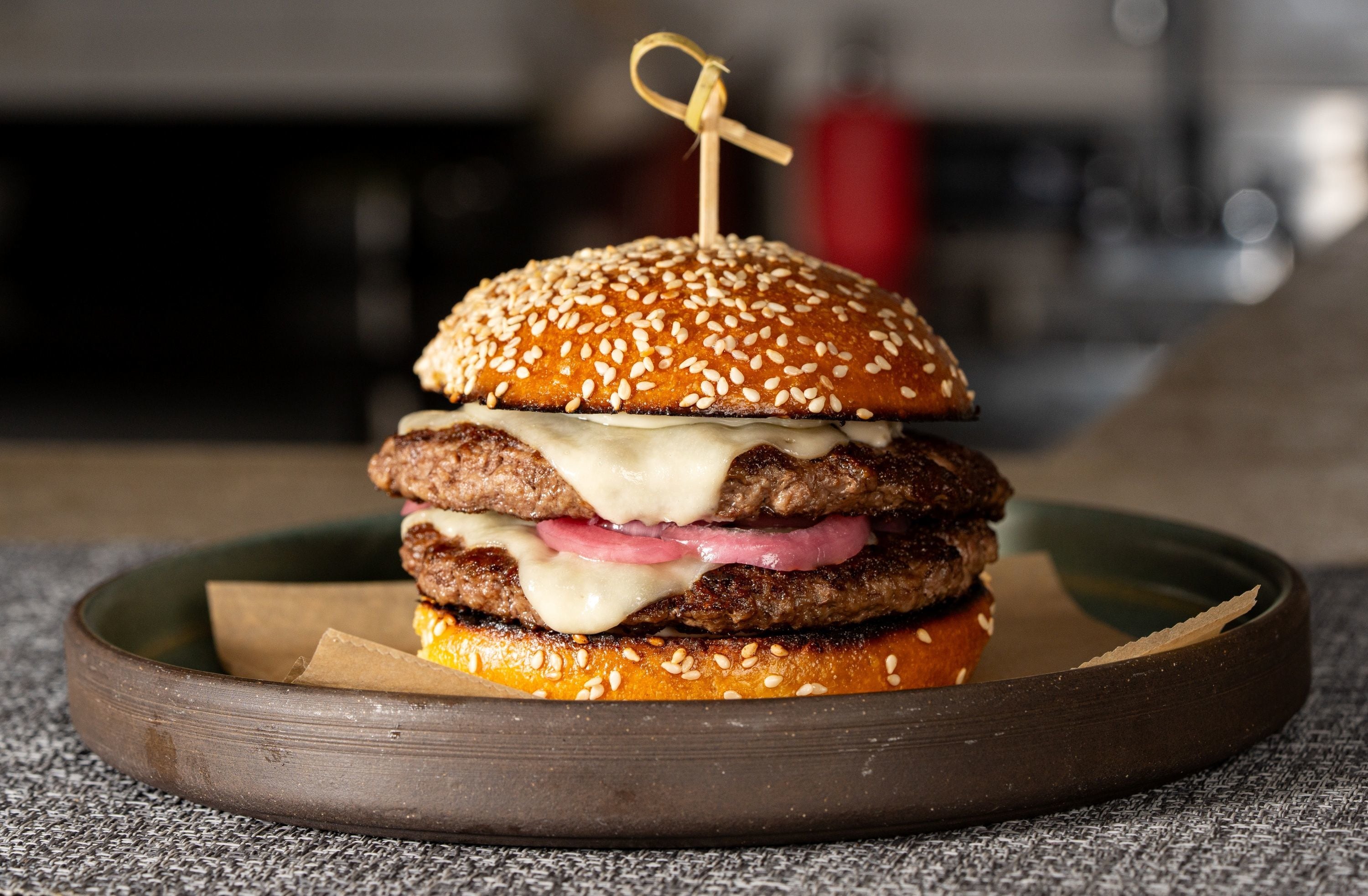 River Twice is expanding next door, bringing more Mother Rucker burgers, more seating, and a bar