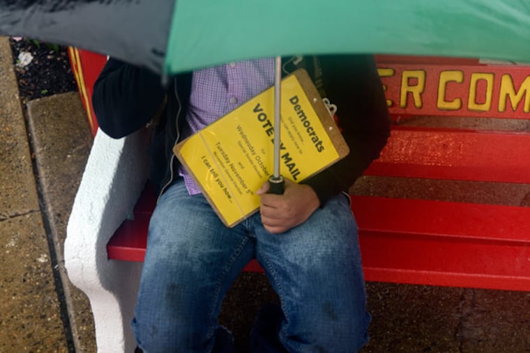 Poll worker Duane Hoke of Camden has the polling place at the Erlton Fire Company to himself August 13, 2013, in the rain as New Jersey votes in a special U.S. Senate primary election to fill out the last 15 months of Frank Lautenberg's term. ( TOM GRALISH / Staff Photographer )