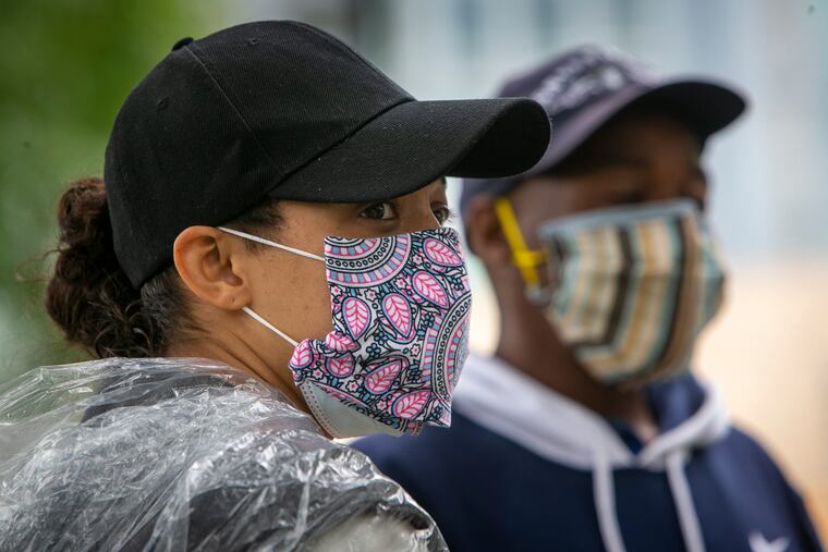 Tara Taylor (left) and Leonard Flowers, at the encampment of people who are homeless on Benjamin Franklin Parkway. Taylor, a community organizer, said nonprofits that help the homeless have been "insufficient."