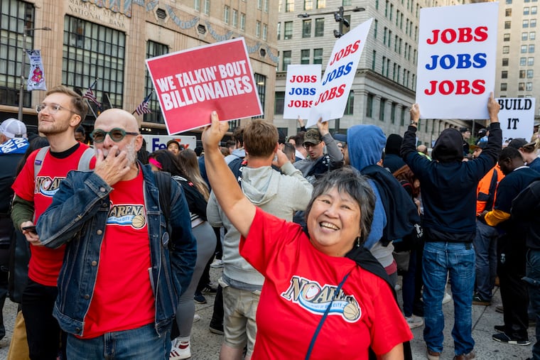 Pro-arena labor supporters (rear) and Save Chinatown Coalition community organizer Debbie Wei (front, center) demonstrate outside City Hall in October.
