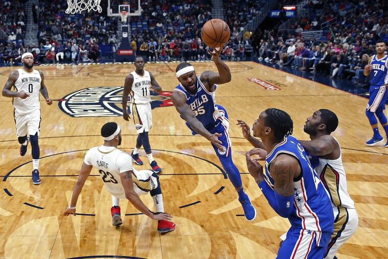 76ers forward Trevor Booker (35) is fouled by New Orleans Pelicans forward Anthony Davis (23) as he drives to the basket in the first half.