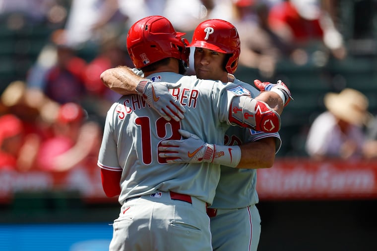 J.T. Realmuto is greeted by Kyle Schwarber after hitting a solo home run during the third inning against the Los Angeles Angels on Sunday.