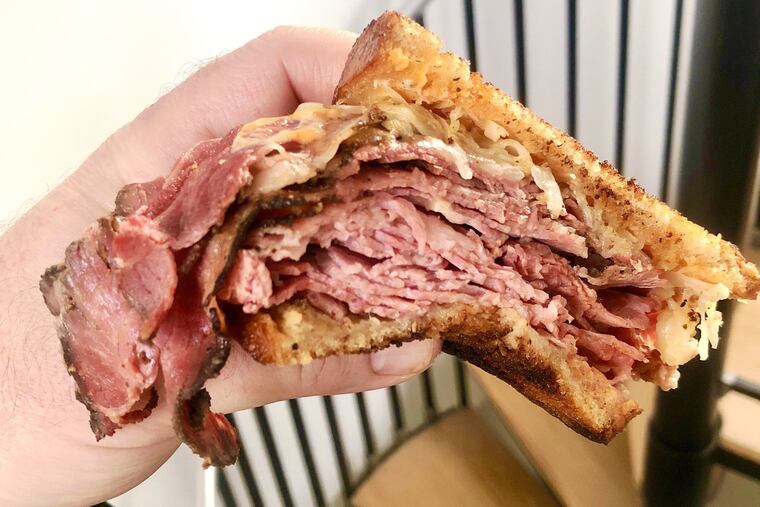 A corned beef and pastrami Reuben from Schlesinger's Deli. A new method for cooking the corned beef has been among the subtle changes recently that have improved the Rittenhouse Square standby.