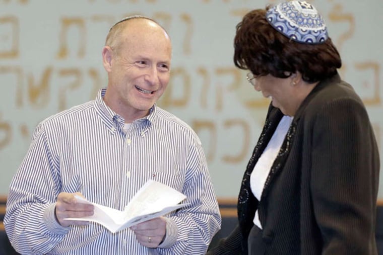 Rabbis Jon Cutler and Debra Bowen. Says Cutler: "Our theme is the unity of African American and white Jews walking across the bridge together - as one." The two have been friends for 15 years.