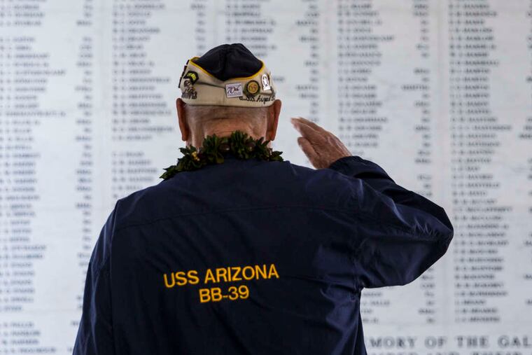 Survivor Louis Conter salutes the remembrance wall of the USS Arizona during a memorial service for the 73d anniversary of the attack that launched the United States into World War II. KENT NISHIMURA / Getty Images