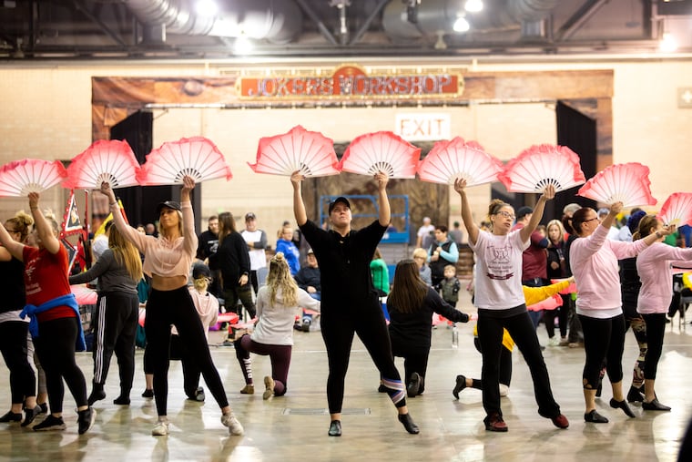 Mummers from the Avenuers brigade rehearses for Mummerfest in the Philadelphia Convention Center Saturday, December 29, 2018.