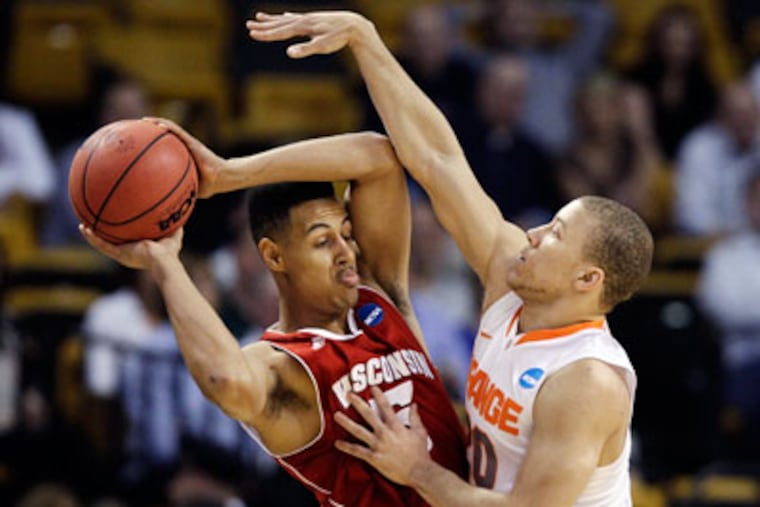 Syracuse guard Brandon Triche pressures Wisconsin forward Ryan Evans in the first half. (Elise Amendola/AP)
