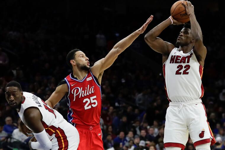 Sixers guard Ben Simmons defends Miami Heat forward Jimmy Butler past center Bam Adebayo during the third-quarter on Saturday, November 23, 2019 in Philadelphia. Butler missed the shot attempt.