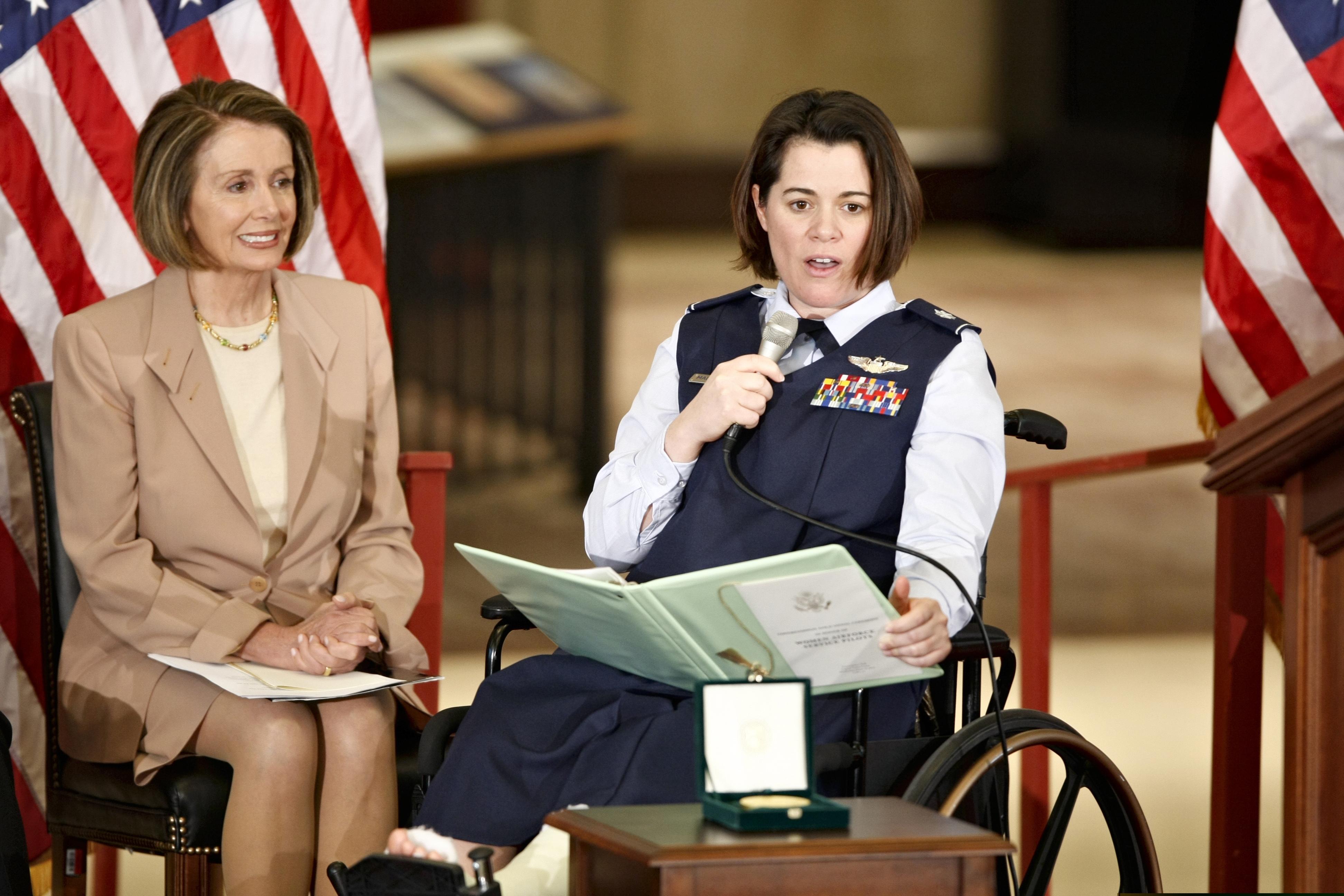 Air Force Lt. Col. Nicole Malachowski (right) is joined by House Speaker Nancy Pelosi at a 2010 ceremony honoring the Women Airforce Service Pilots on Capitol Hill in Washington. Malachowski, who was the first woman to fly with the Thunderbirds and was inducted into the National Women's Hall of Fame in 2019, has had parts of her story scrubbed from the Air Force webpage to conform with President Donald Trump's DEI purge.