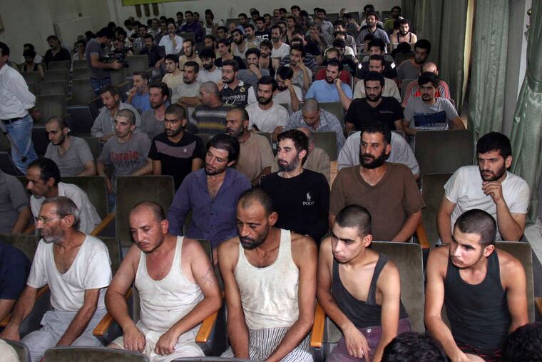 Syrian detainees who took part in antigovernment protests sit in a courtroom in Damascus, Syria. Human-rights groups say thousands have disappeared over the last two years.