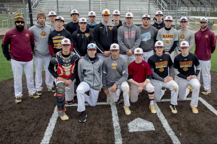 The Gloucester Catholic baseball team poses for a photo before a scrimmage at Eastern, March 27, 2018. Head coach Adam Tussey is at far right. TOM GRALISH / Staff Photographer