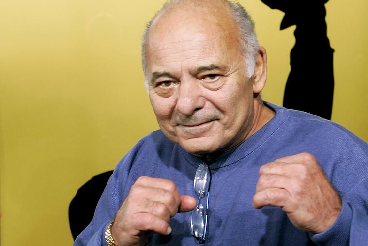 Burt Young, a cast member of the film "Rocky Balboa," gestures at the premiere of the film in Los Angeles, Dec. 13, 2006. Young, the Oscar-nominated actor who played Paulie, the rough-hewn best friend and brother-in-law to Sylvester Stallone in the “Rocky” franchise, died Oct. 8, 2023 in Los Angeles.