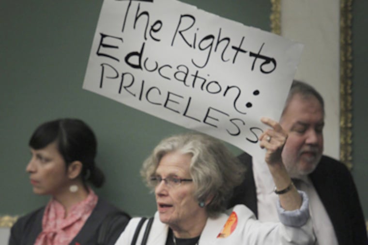 Shelly Yanoff with Public Citizens for Children and Youth holds a sign in support of education during a public hearing. (Alejandro A. Alvarez / Staff Photographer)