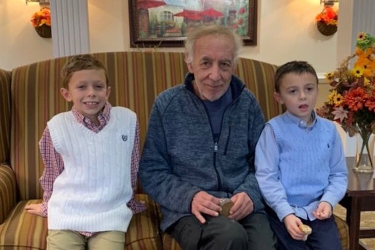 Martin Kaplan, center, sits with his grandsons in a photo provided by his daughter, Caroline Morris. Kaplan left the assisted living facility where he lived while residents' movements were restricted to mitigate the spread of the virus.