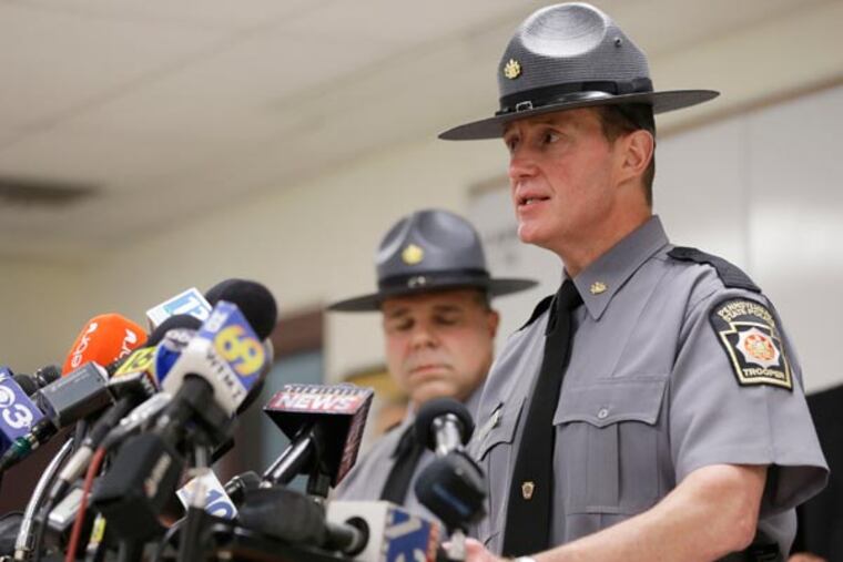 Pennsylvania State Police Capt. Edward Hoke, accompanied by, Lt. Col. George Bivens, speaks during a news conference, Tuesday, Aug. 6, 2013, in Stroudsburg, Pa. A man has been arraigned on homicide charges and other counts after police say he fatally shot three people during a municipal meeting in the Poconos amid a dispute with the township. The gunman, identified as 59-year-old Rockne Newell, indiscriminately fired shots Monday night as he barged into the meeting, authorities said. He left long enough to get another weapon from his car and continued firing upon returning until he was tackled by at least one person and was shot with his own gun, police and witnesses said. (AP Photo/Matt Rourke)
