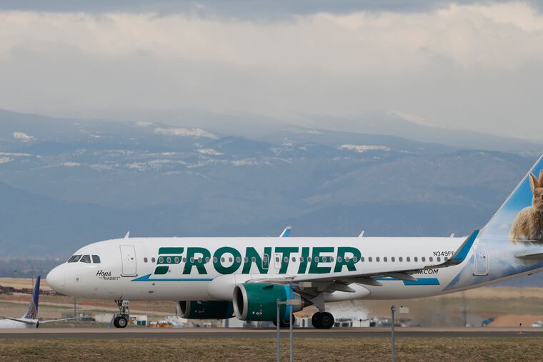 A Frontier Airlines jetliner taxis to a runway to take off from Denver International Airport in 2020.