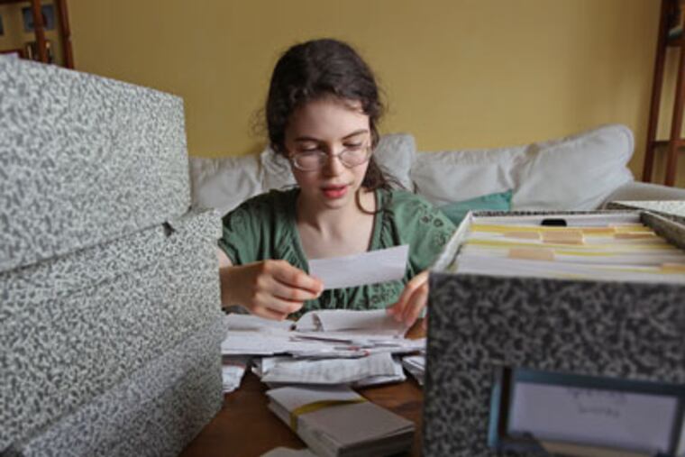 Lena Greenberg, 14, looks over some of the 12,000 words she has stored on index cards for spelling practice. "She's not just smart, she's very wise. She has really tremendous insight." says her mother. MICHAEL BRYANT / Staff Photographer