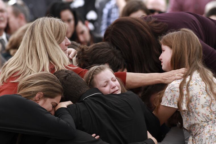 Family and friends weep during the funeral service for Dawna Ray Langford, 43, and her sons Trevor, 11, and Rogan, 2, who were killed in an ambush earlier this week, in La Mora, Mexico, Thursday, Nov. 7, 2019. As Mexican soldiers stood guard, the three were laid to rest in a single grave at the first funeral for the victims of a drug cartel ambush that left nine American women and children dead.