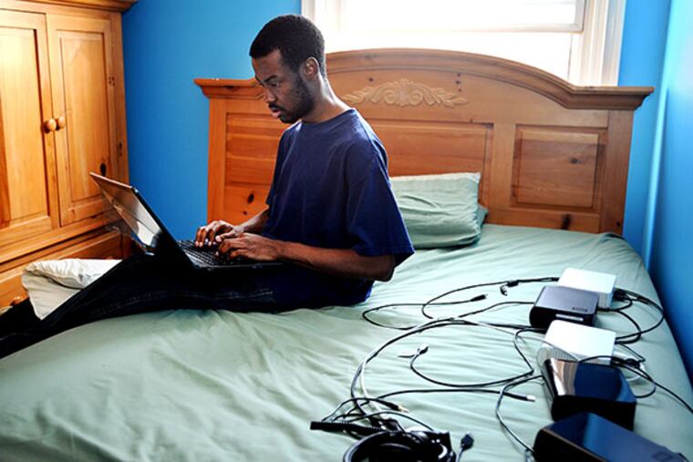 Stanley Joseph, a Penn State grad, desperately wants a job in the computer field. He works on his computer looking for jobs, in his Philadelphia home. ( SHARON GEKOSKI-KIMMEL / Staff Photographer )