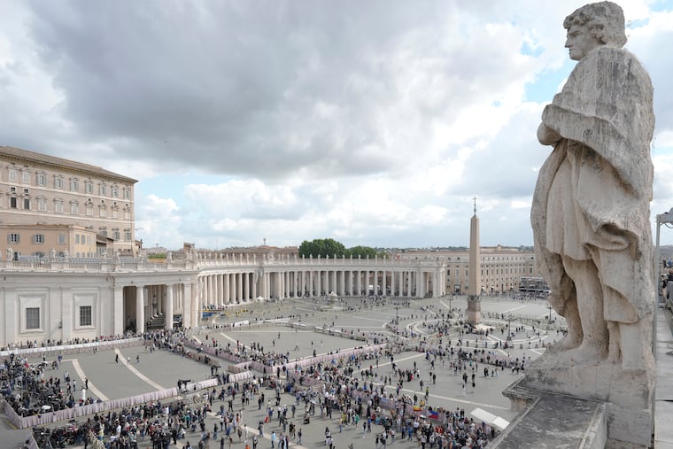People arrive at St. Peter's Square at the Vatican where 133 cardinals gather on the second day of the conclave to elect successor of late Pope Francis, Thursday, May 8, 2025.