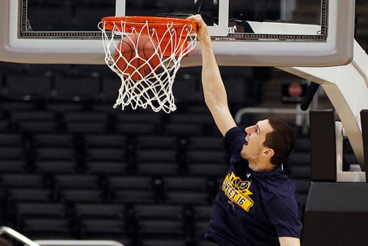 La Salle's Steve Zack dunks the basketball during practice at the Staples Center in Los Angeles on Wednesday, March 27, 2013. (Yong Kim/Staff Photographer)