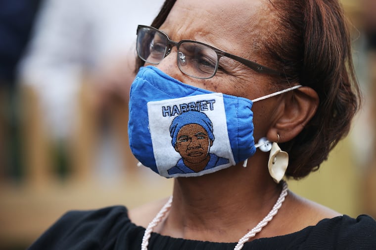 Lynda Anderson-Towns, chair of the board of trustees, listens during the opening ceremony for the Harriet Tubman Museum.