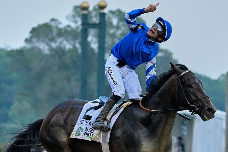 Jockey Junior Alvarado celebrates aboard Sovereignty after crossing the finish line to win the 157th running of the Belmont Stakes horse race.