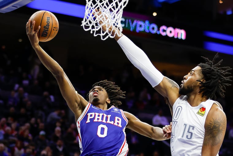 Sixers guard Tyrese Maxey drives to the basket against Oklahoma City Thunder center Derrick Favors in the first quarter on Friday, February 11, 2022 in Philadelphia.