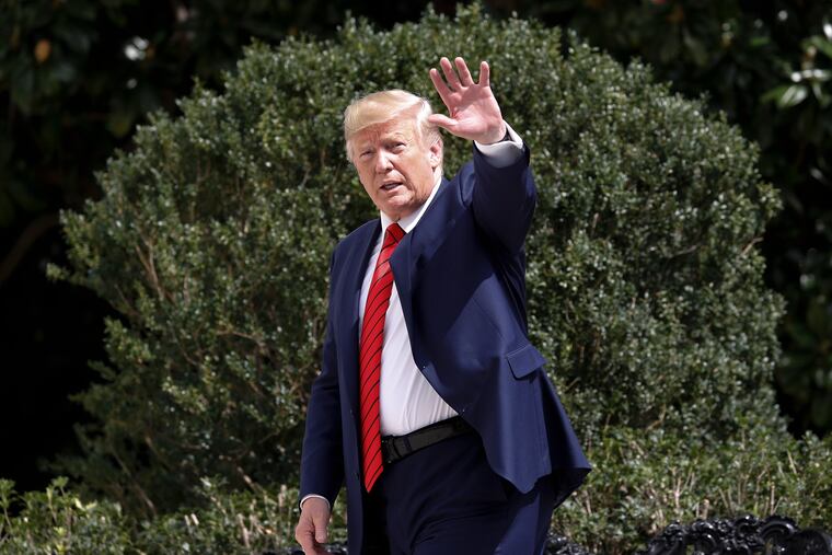 President Donald Trump gestures towards members on the media on the South Lawn of the White House in Washington, Thursday, Sept. 26, 2019, after returning from United Nations General Assembly, and two days after House Speaker Nancy Pelosi announced a formal impeachment inquiry into his presidency.