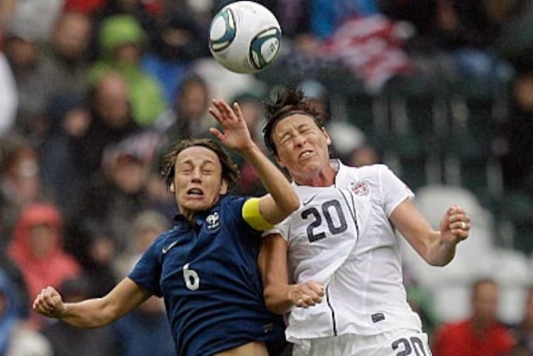 Abby Wambach goes up for a header against France's Sandrine Soubeyrand on Wednesday. (Marcio Jose Sanchez/AP)