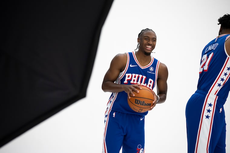 Sixers guard Tyrese Maxey laughing with center Joel Embiid during the team's media day.