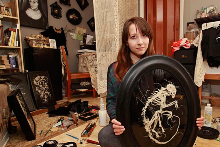 Caitlin T. McCormack with a "lemur" skeleton she crocheted. (MICHAEL BRYANT / Staff Photographer)