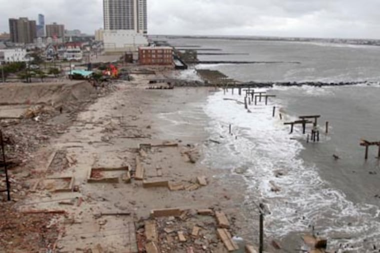 Foundations and pilings are all that remain of brick buildings and a boardwalk in Atlantic City, N.J., Tuesday, Oct. 30, 2012, after they were destroyed when a powerful storm that started out as Hurricane Sandy made landfall on the East Coast on Monday night. (AP Photo/Seth Wenig)