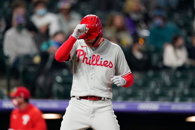 The Phillies' Rhys Hoskins taps his helmet as he crosses home plate after hitting a three-run home run off Rockies reliever Jhoulys Chacin during the sixth inning.