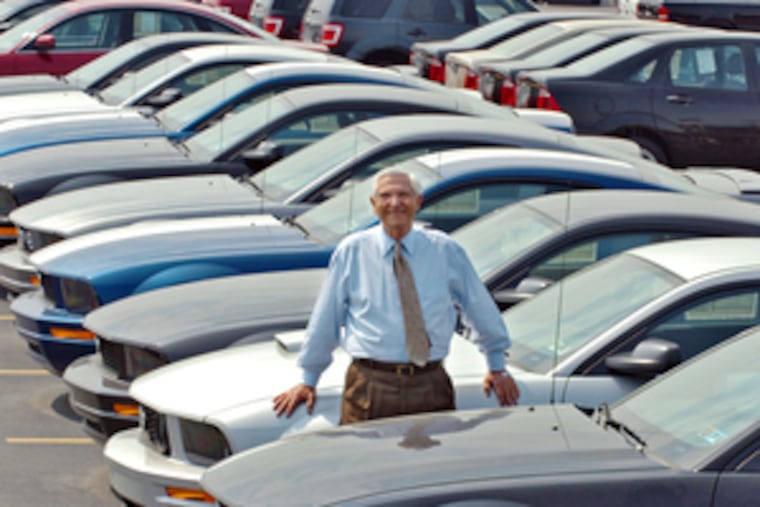Ford dealer Kerry T. Pacifico, 83, in one of his lots near the airport. "We're on an upswing. We can't go any lower. Other dealers are closing and that will help us," said Pacifico, who started in the business in 1954.