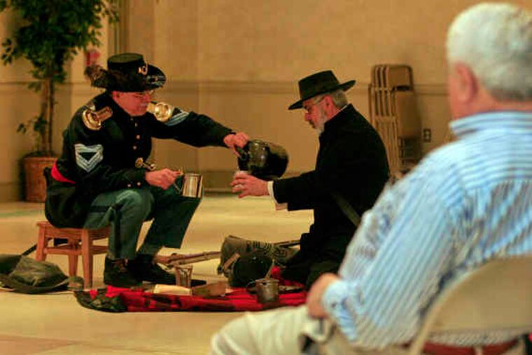 Local synagogues explore the lives of Jews during the war with such reenactors as Morris Farnum (right) and George Yarnell.