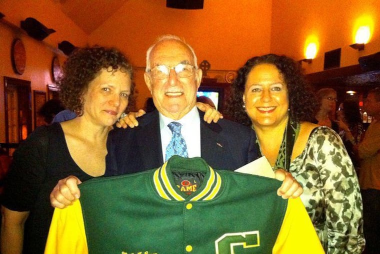 Mr. Brown at the 40th anniversary celebration for the Greenfield School, holding a custom letterman jacket.