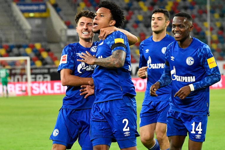 Schalke's American midfielder Weston McKennie (2) celebrates with teammates - albeit not in a socially-distanced way - after scoring a goal against Fortuna Düsseldorf on Wednesday.